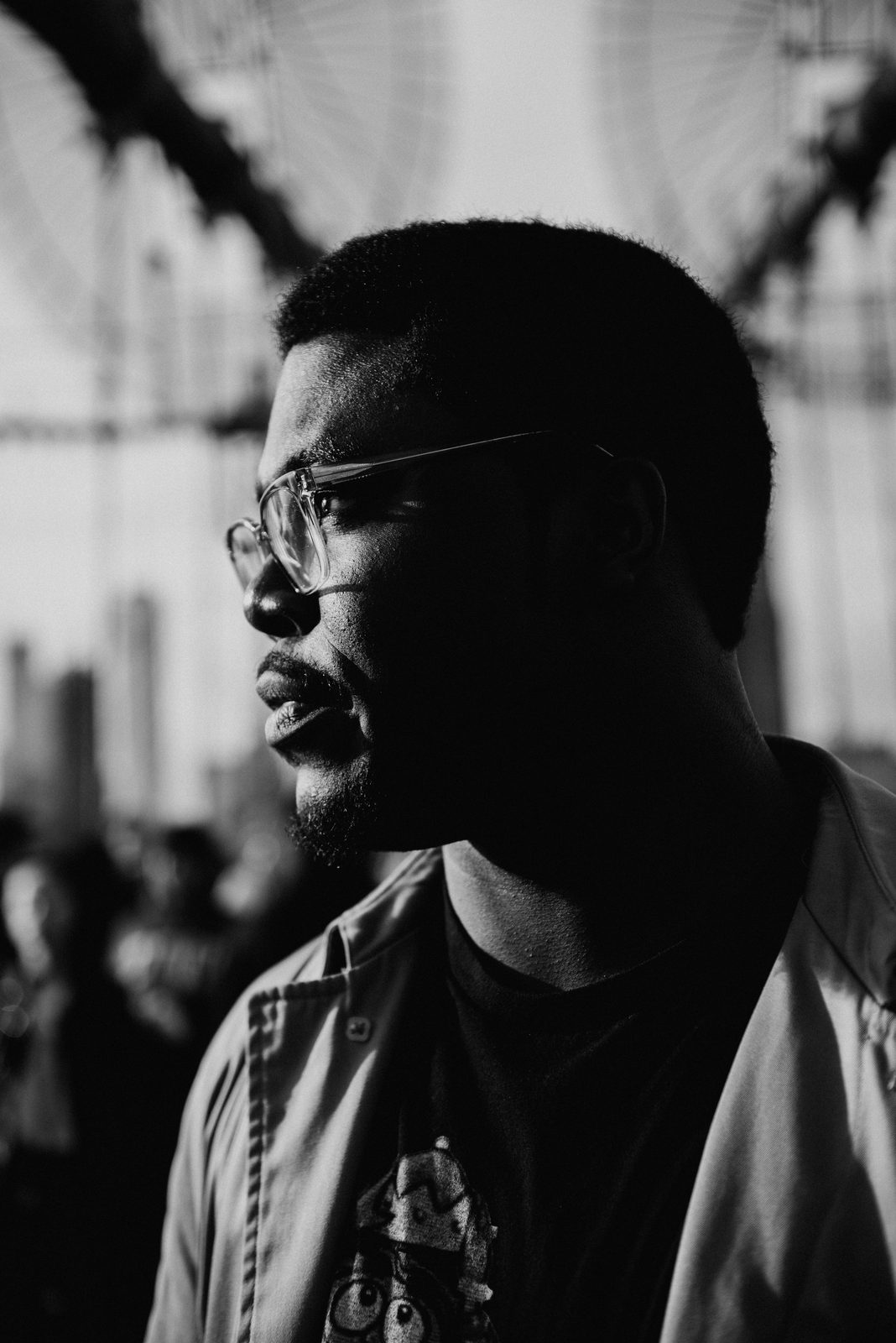 Shawn in profile on the Brooklyn Bridge, in black and white