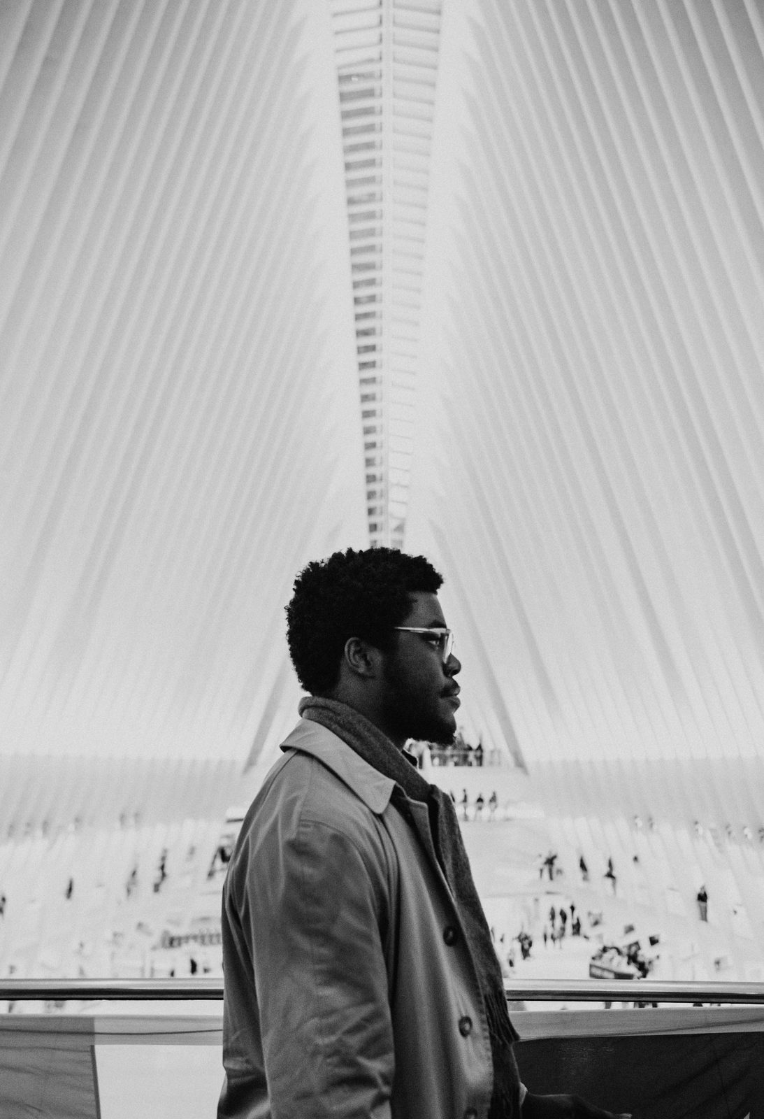 Shawn in profile under the white ribs of the Oculus, in black and white